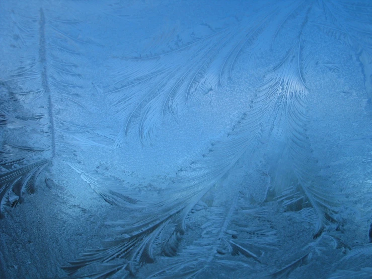 some ice is seen on the window of a car