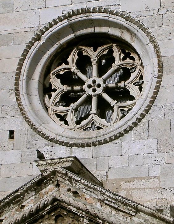 the round stained glass window is designed to look like flowers