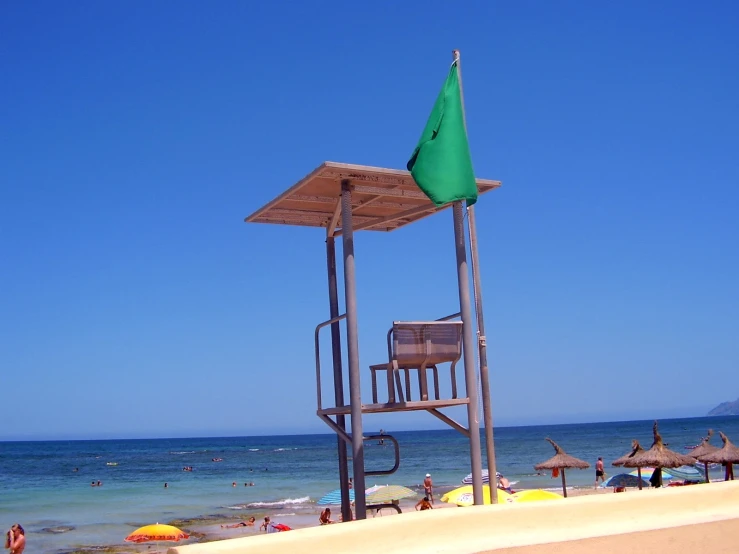 a life guard stand and chair on a sandy beach