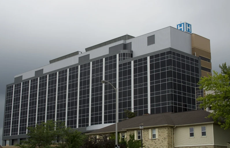 a tall, black and grey building sitting on the corner of a street