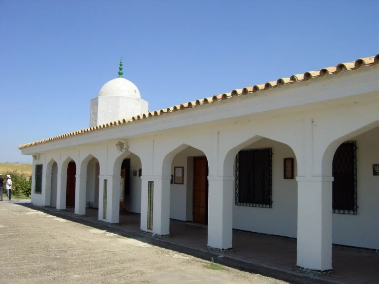 several white colonial style building with pillars and a white dome