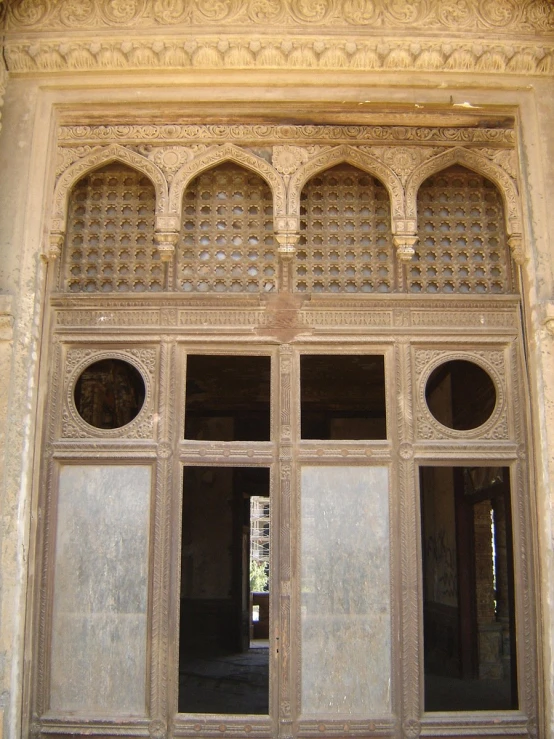 an intricate, ornate entry way to a building with wood and stucco