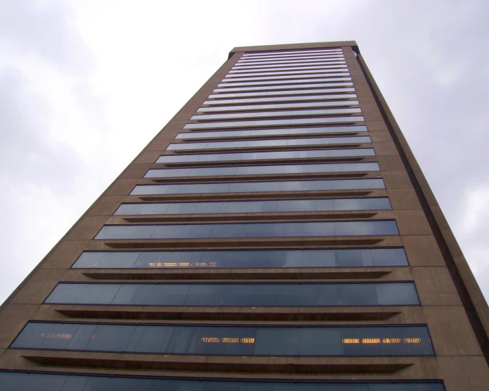 an upward view of a tall skyscr with lots of windows