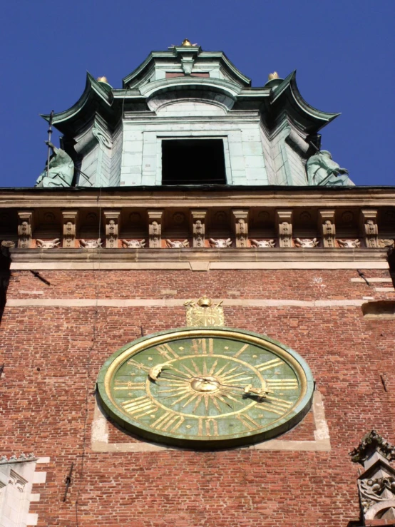 a clock tower with a sun dial sitting above the roof