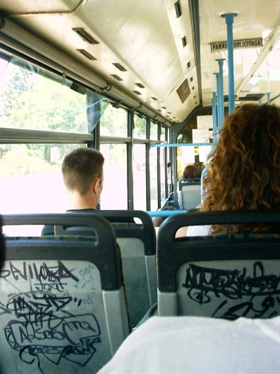 the back end of a bus with many graffiti on it