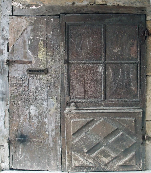 an old door with ornate wood and window panes