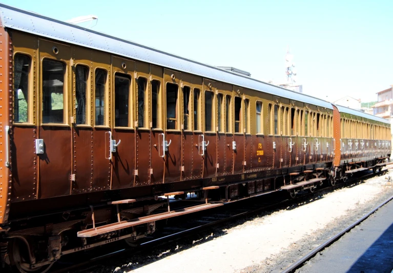 a train sitting on the tracks near a street