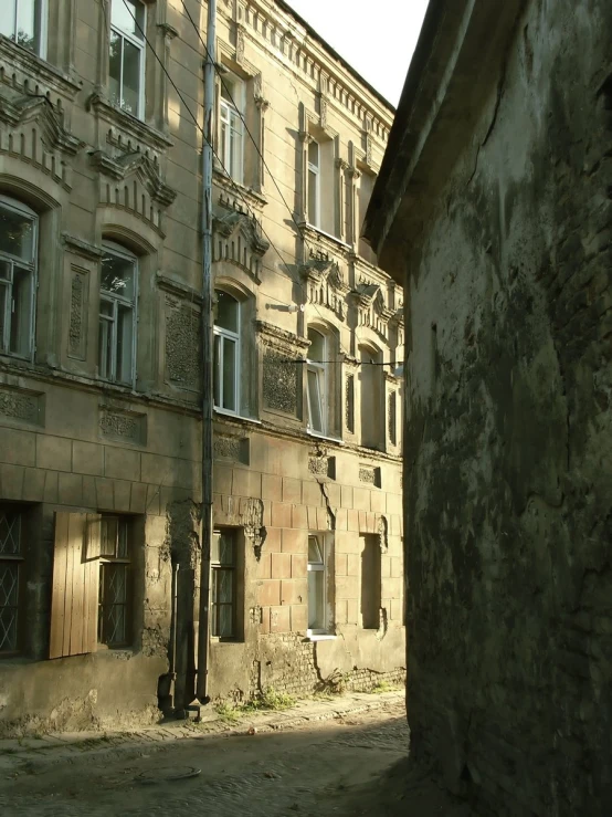 an abandoned, run down city block with a broken clock on it