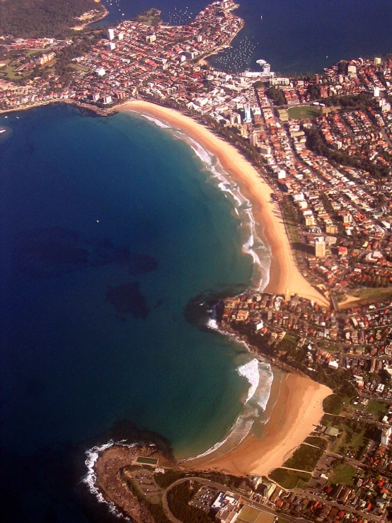 an aerial view of a coastline and town