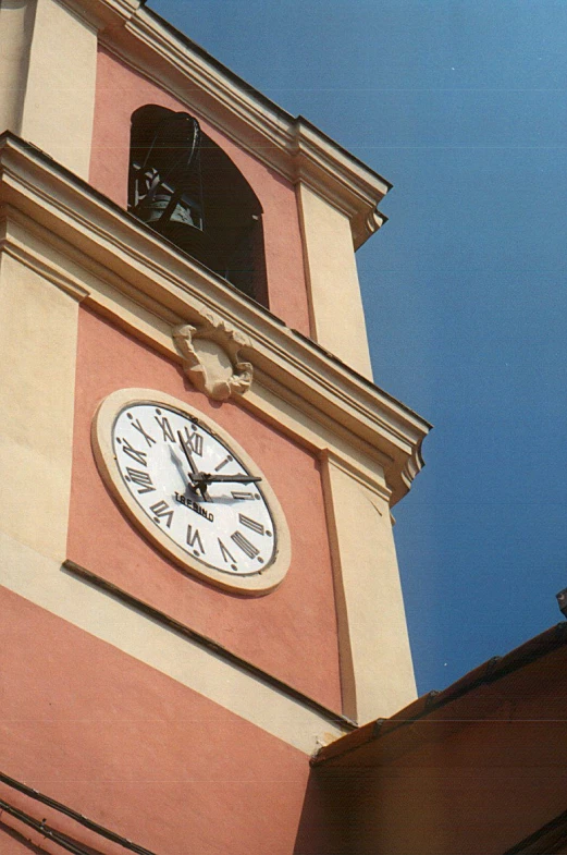 a white clock and brown clock tower with sky in background
