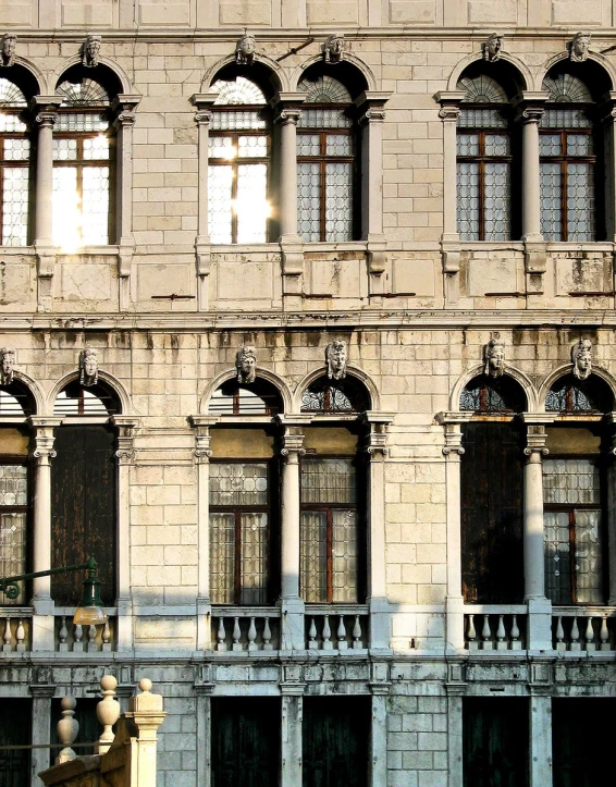 an old building has ornate windows, balconies, and an iron fence