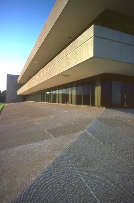 an empty building with lots of windows that is facing away from the street