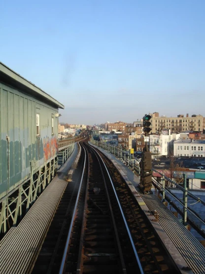a train track with several sets of train tracks near buildings