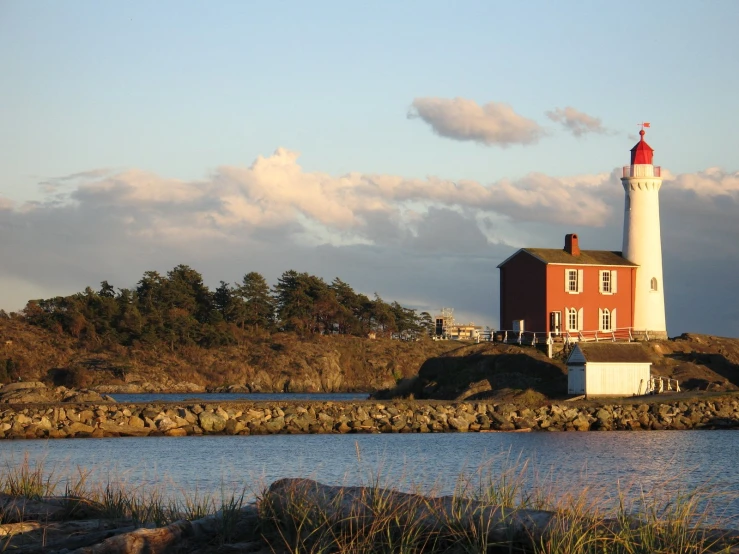 a light house on a hill that has a light house