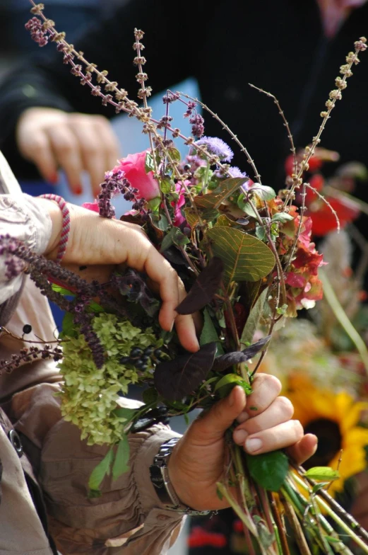 the woman is placing flowers in her hands