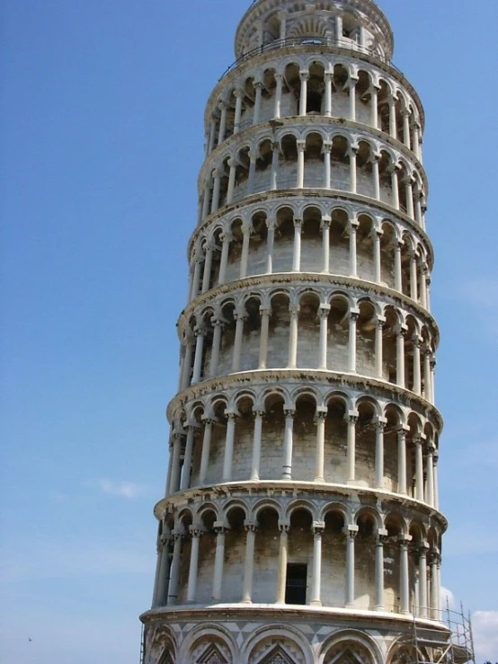 a large white brick structure with a tall tower