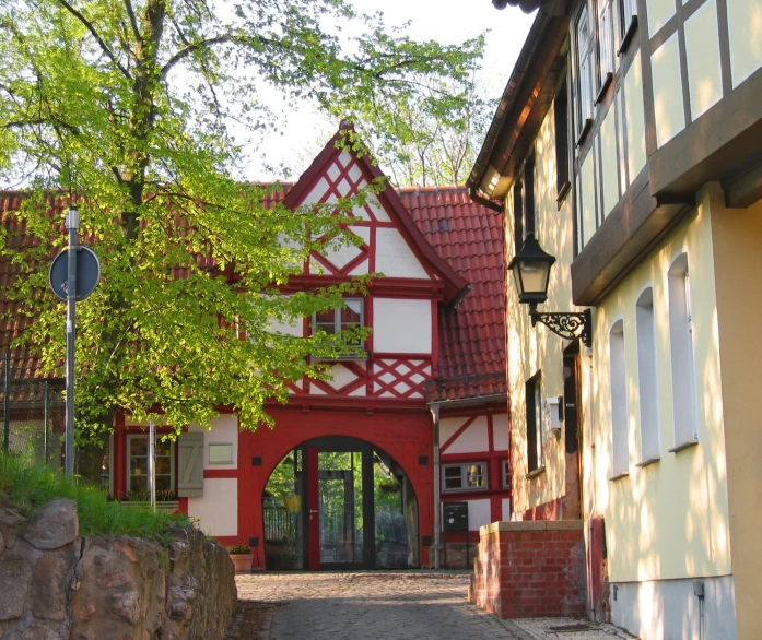 a red and white building and tree by it