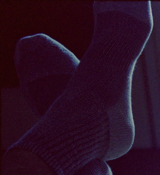 a woman's feet in socks against a window