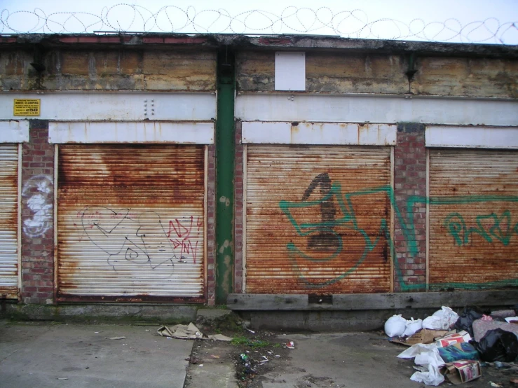 an old building with lots of shutters and trash