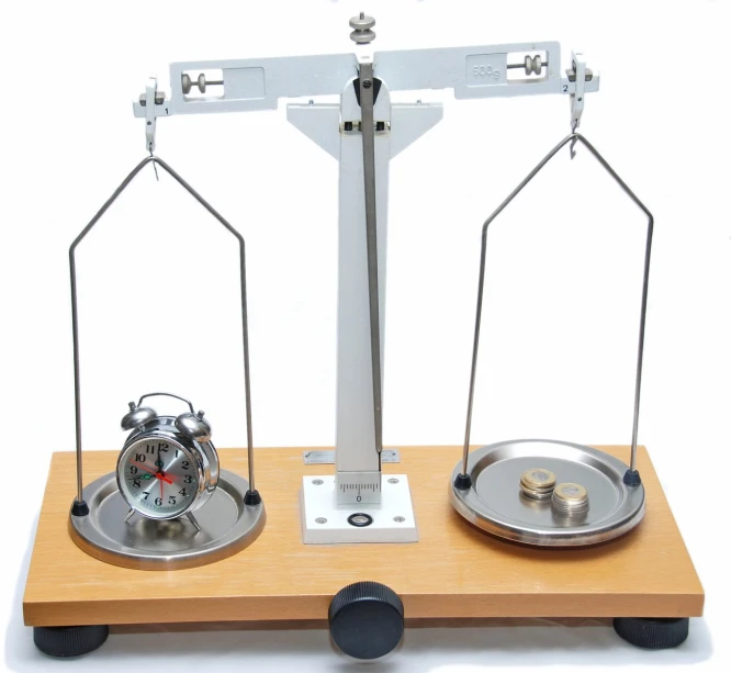 two metal scale weighings with clocks inside of them