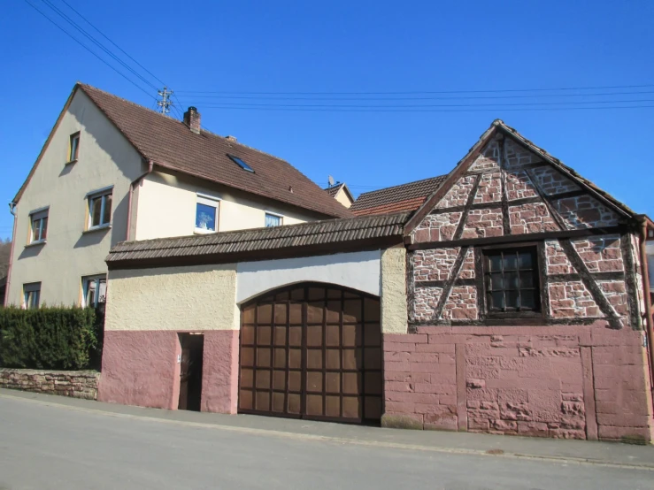 a couple of large garage doors in front of a brick building