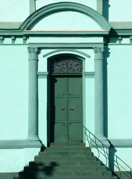 stairs lead up to the door and upper portion of a building