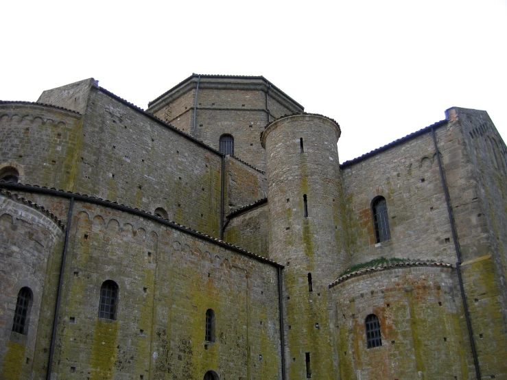 a stone castle with two clocks on each side