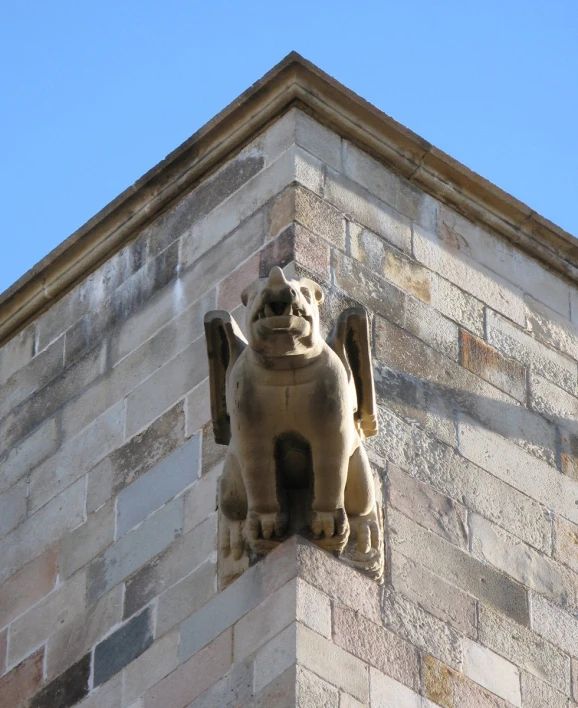 a sculpture of a dog on the side of a building