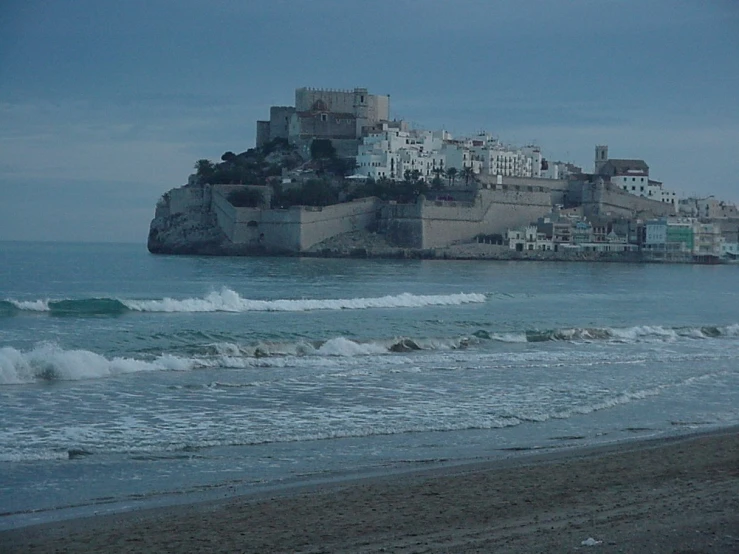 the beach is by an oceanfront with buildings on it