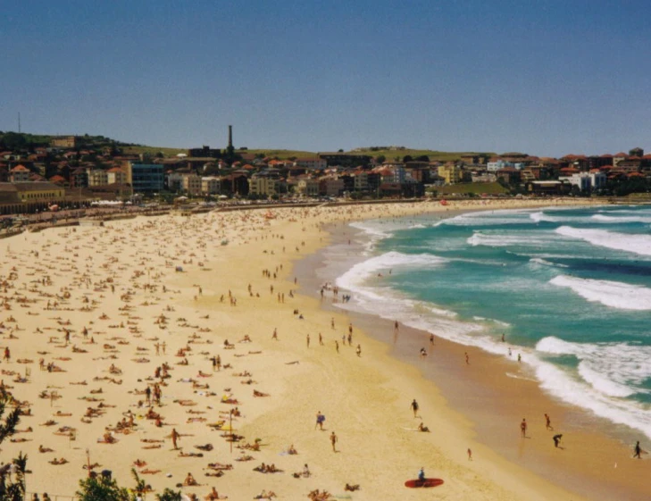 many people are in the sand on a sunny day