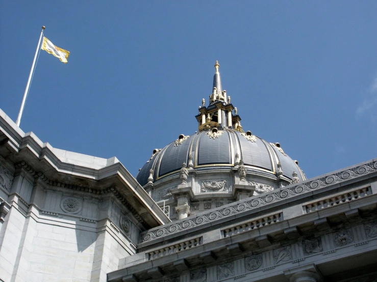 a large gray dome with a gold and white flag at the top