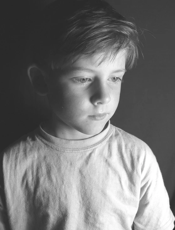 a boy standing in front of a white wall