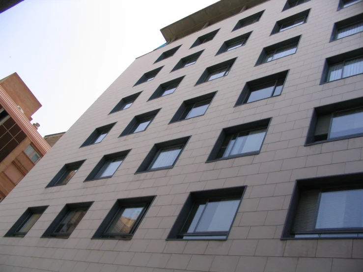 a building with several windows and a clock on it