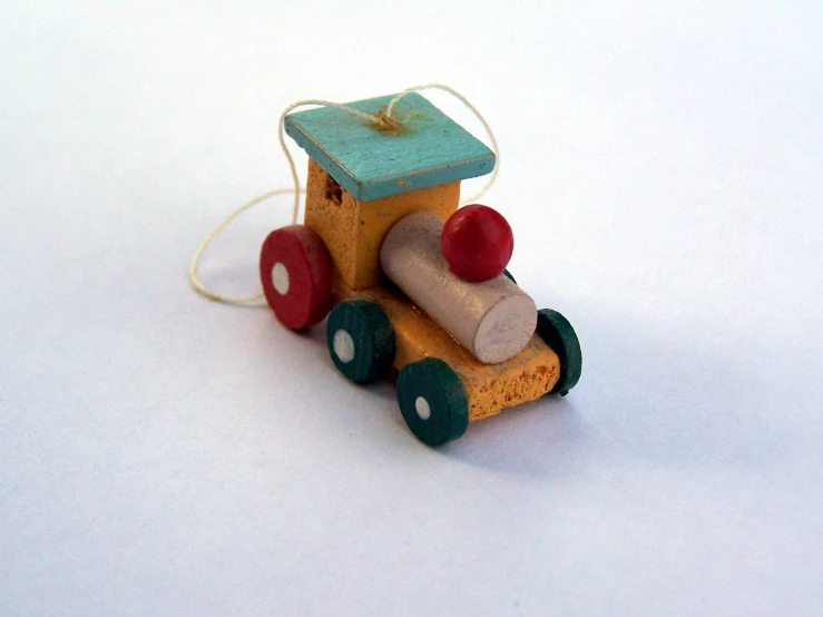 small toy truck ornament in front of a white background