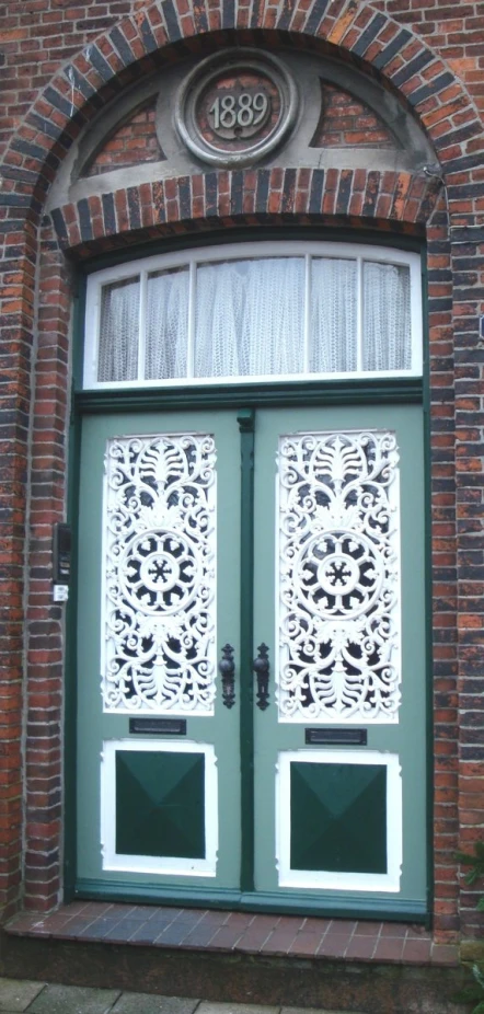 this is a green door with two windows