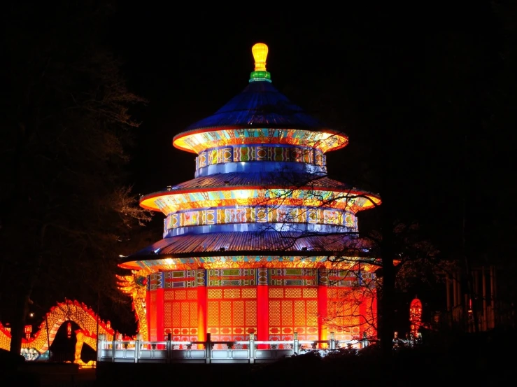 colorful lighted pagoda in a lit up area