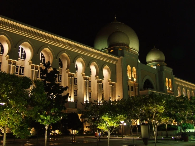 an elegant building is lit up at night