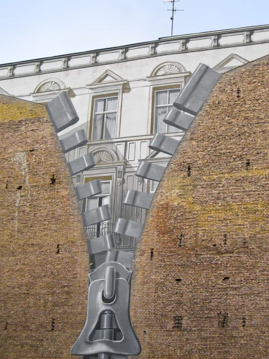 a mural of a giant head and building is in the background