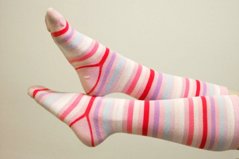 the legs and toes of a person in striped socks