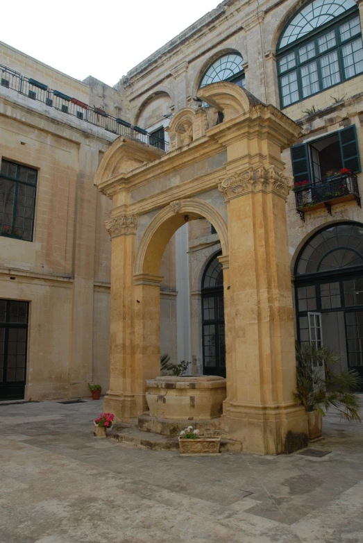 an old building has a stone fountain in the courtyard