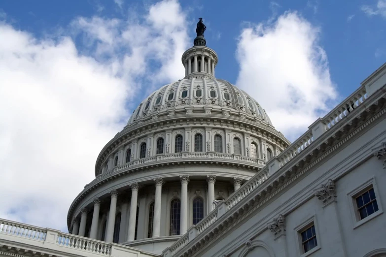 the capitol building is against a beautiful blue sky