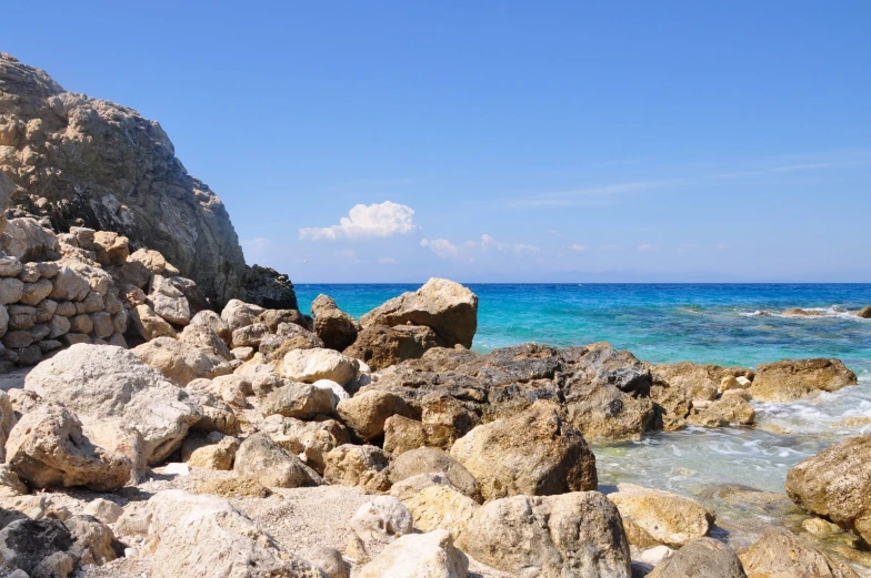 large rocks sticking out from the ocean shore