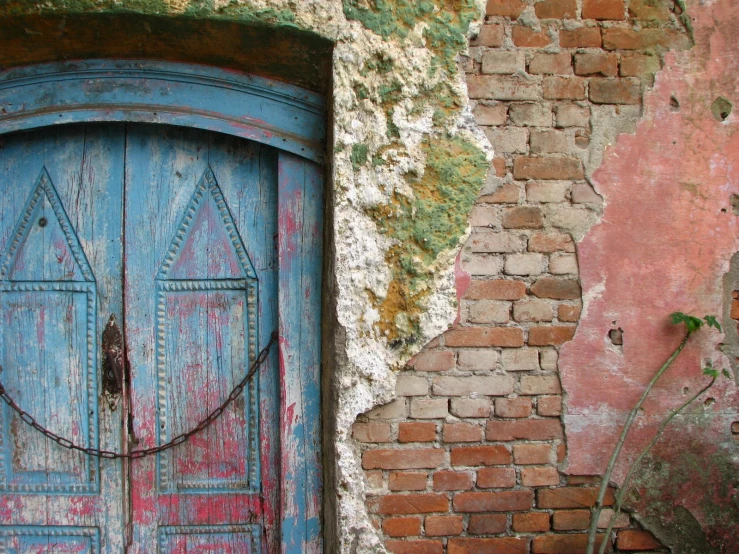 an old building with brick walls and painted doors