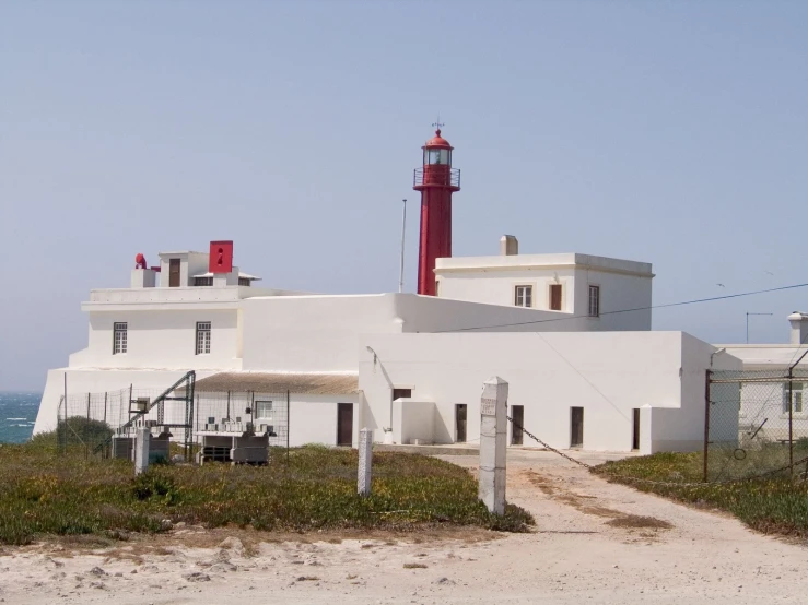 an unusual house with a lighthouse on the roof