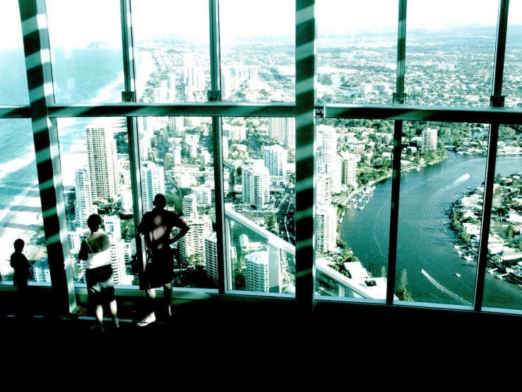 a couple of people sitting on top of a building