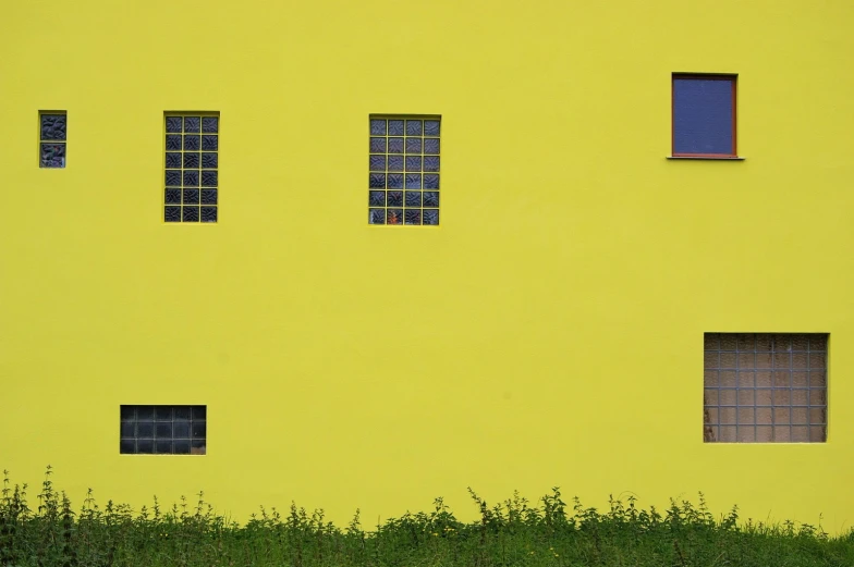 a very tall yellow building with many windows