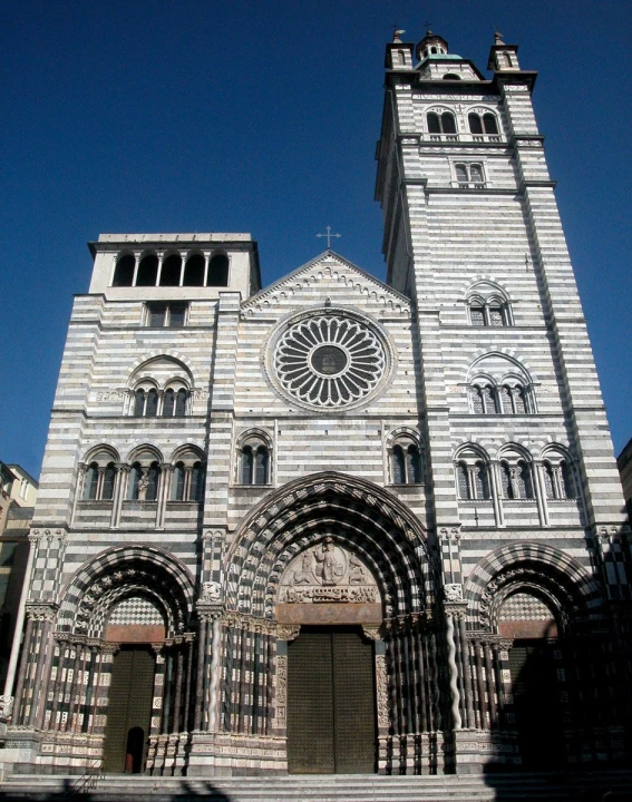 the tall clock tower is shown on top of this stone building