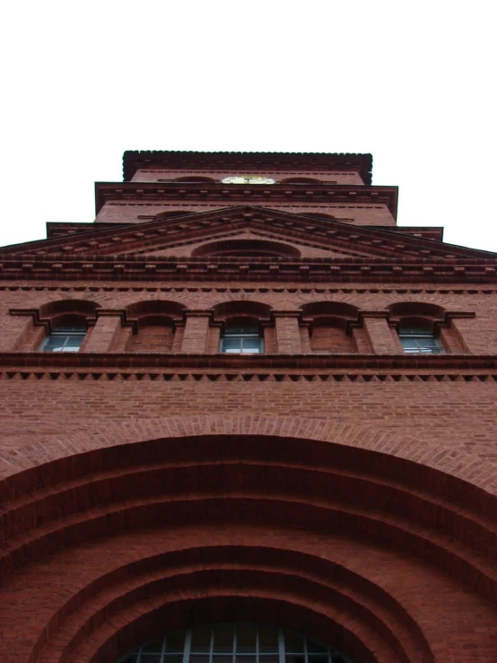 red brick building with arched windows and clock