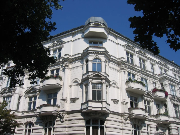 a building with several balconies on the top floor