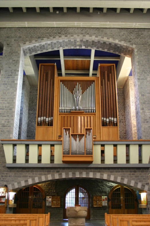 a beautiful room filled with wood furniture and a pipe organ